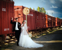 Image showing a bride and groom at Cross Orchards, in front of the rail cars