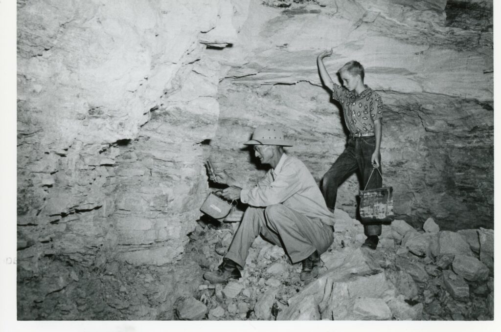 A man and a boy prospecting for uranium.